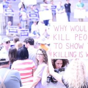 AMPEZZAN/Arkansas Public Media - 4/17/2017 - A protester hols up a sign at an End the Death Penalty rally at the Arkansas state capital.