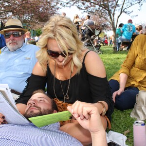 Arkansas Democrat-Gazette/BOBBY AMPEZZAN - 4/12/14 - Mandy Wallace and Nick Allen of Fayetteville go over their picks while Scott Allen of Fayetteville and Kathy Wallace of Harrison eye the camera at the 78th running of the Arkansas Derby at Oaklawn Park.