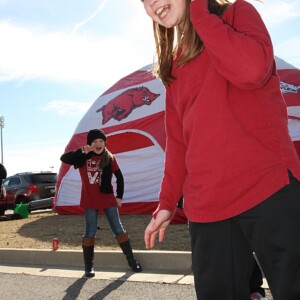 Arkansas Democrat-Gazette/BOBBY AMPEZZAN / 1/2/16 / Abbie Martin, 10, and Brooklyn Miller (behind), 11, both of Marion, at the Liberty Bowl in Memphis.