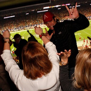 Arkansas Democrat-Gazette/BOBBY AMPEZZAN - 12/29/14 - Country music star Joe Nichols celebrates a University of Arkansas Razorbacks touchdown inside the UA box at NRG Stadium in Houston for the Texas Bowl between Arkansas and Texas.